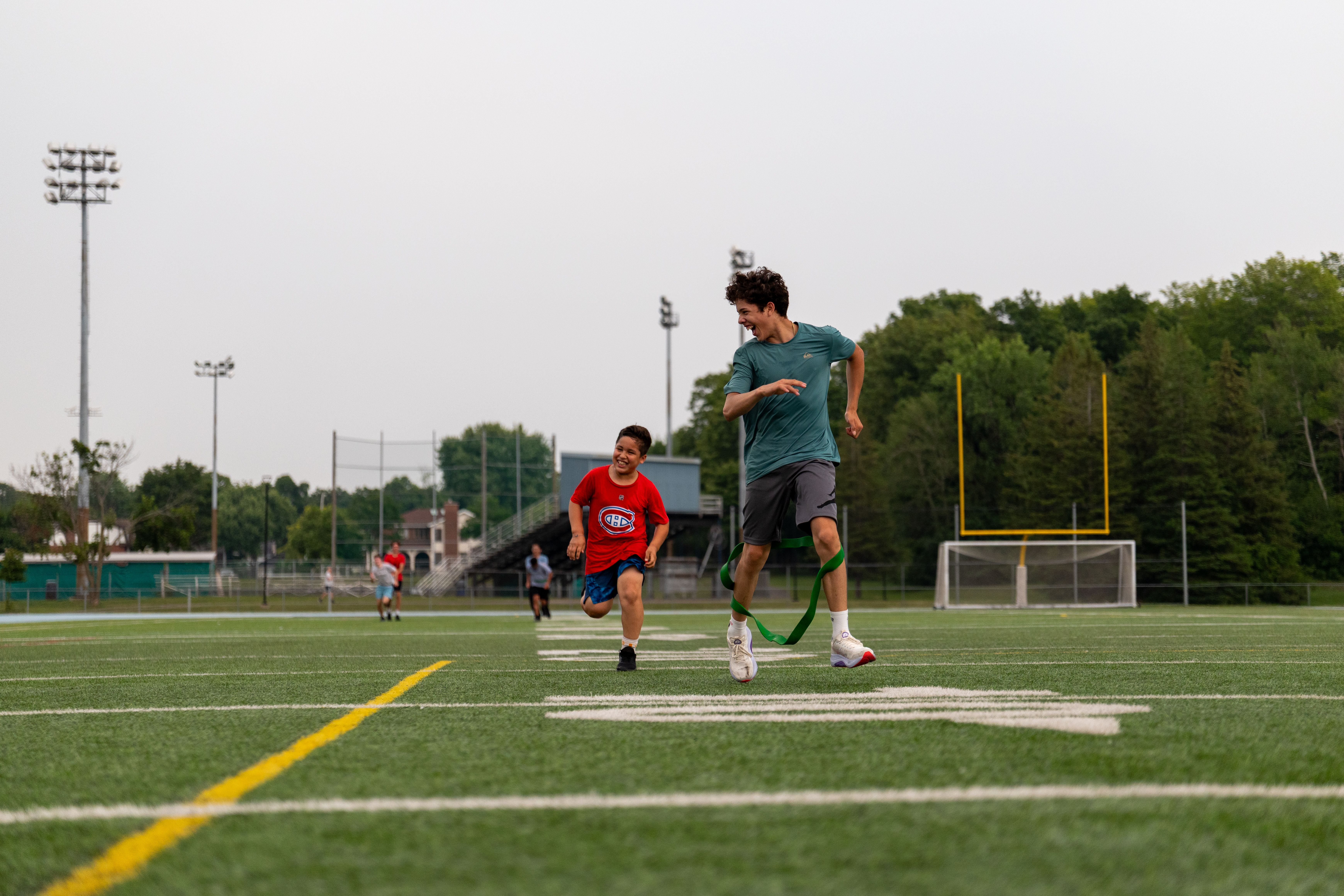 Coach training an athlete on a football field