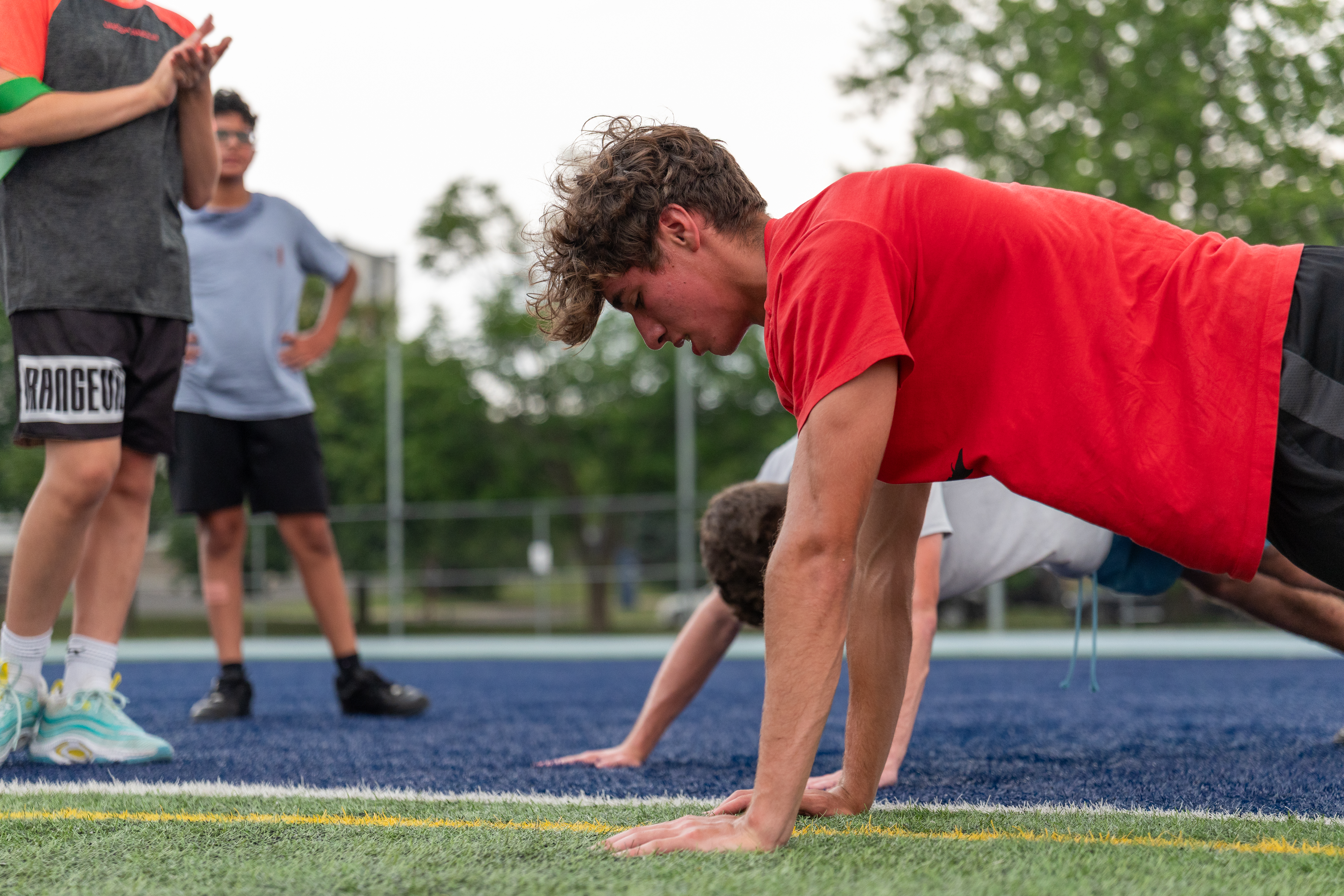 Coach working with an athlete during outdoor training