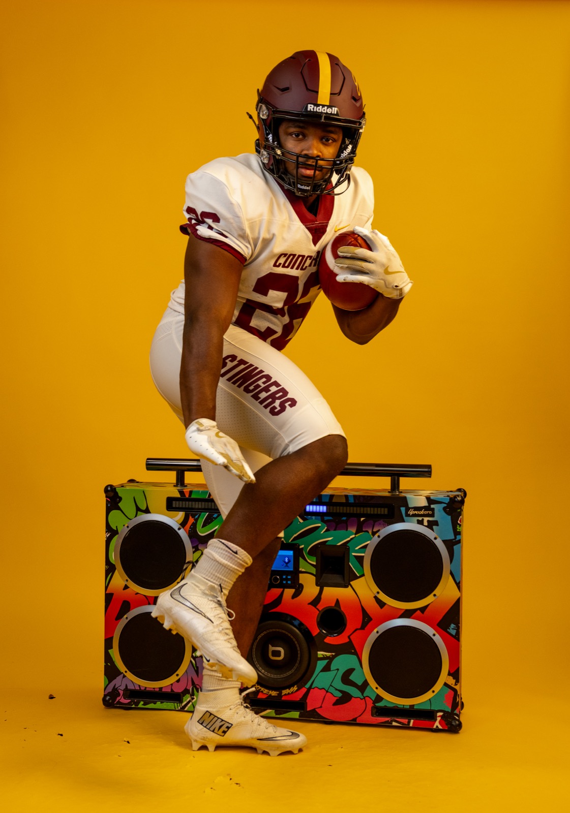 Concordia Stingers player posing with a football during media day